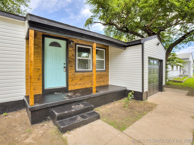 3226 N Garrison Ave, Tulsa, OK 74106 - doorway to property with an attached garage and concrete driveway