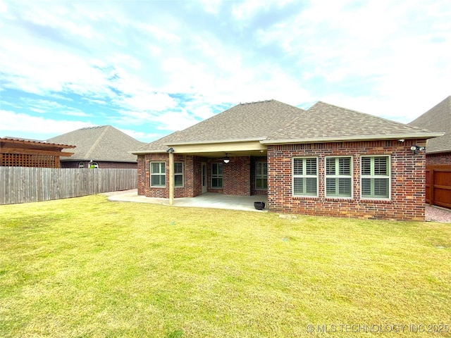 4706 S 182nd E Ave, Tulsa, OK 74134 - rear view of property featuring brick siding, a shingled roof, a patio, and a fenced backyard