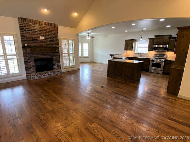 4706 S 182nd E Ave, Tulsa, OK 74134 - kitchen featuring appliances with stainless steel finishes, open floor plan, a center island, dark brown cabinets, and recessed lighting