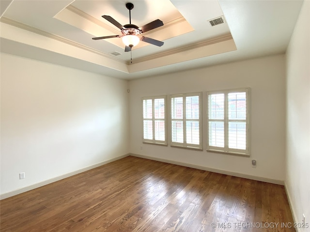 4706 S 182nd E Ave, Tulsa, OK 74134 - spare room with a raised ceiling, healthy amount of natural light, crown molding, wood finished floors, and ceiling fan