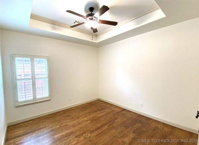 4706 S 182nd E Ave, Tulsa, OK 74134 - empty room featuring a raised ceiling, crown molding, a ceiling fan, and wood finished floors
