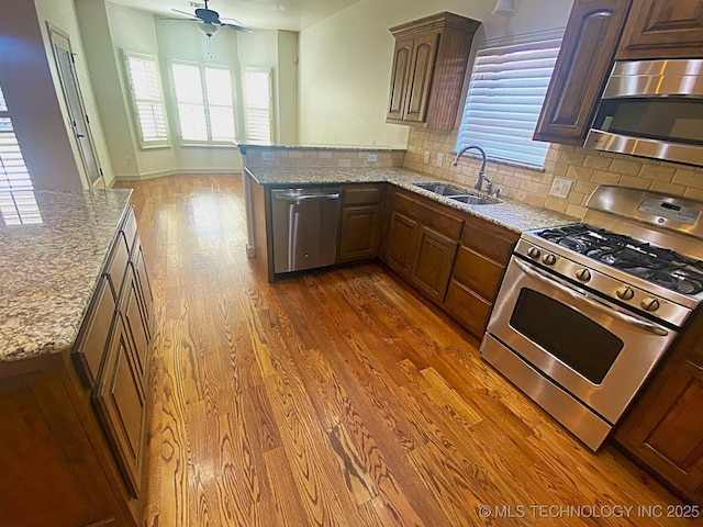 4706 S 182nd E Ave, Tulsa, OK 74134 - kitchen featuring stainless steel appliances, dark wood-style flooring, plenty of natural light, and tasteful backsplash