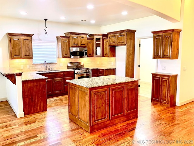 4706 S 182nd E Ave, Tulsa, OK 74134 - kitchen with stainless steel appliances, a peninsula, backsplash, light wood finished floors, and recessed lighting