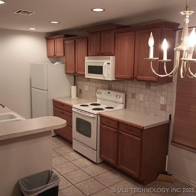 200 Ogeechee, Ramona, OK 74061 - kitchen featuring white appliances, a chandelier, light tile patterned flooring, light countertops, and recessed lighting