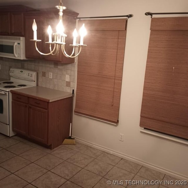 200 Ogeechee, Ramona, OK 74061 - kitchen with white appliances, light tile patterned flooring, a chandelier, light countertops, and backsplash