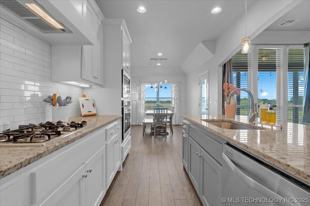30130 S Maxine Ave, Inola, OK 74036 - kitchen featuring stainless steel appliances, white cabinets, decorative light fixtures, backsplash, and recessed lighting