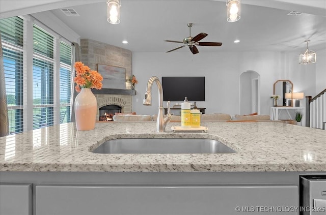 30130 S Maxine Ave, Inola, OK 74036 - kitchen with open floor plan, ceiling fan, light stone countertops, recessed lighting, and a large fireplace