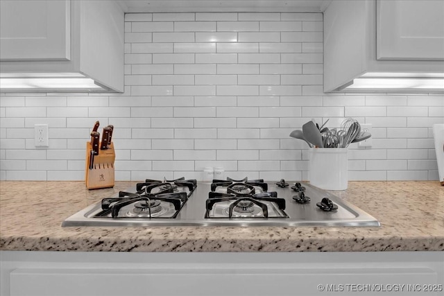 30130 S Maxine Ave, Inola, OK 74036 - kitchen view of stainless steel gas cooktop, decorative backsplash, and white cabinetry