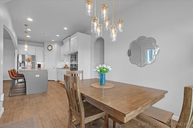30130 S Maxine Ave, Inola, OK 74036 - dining room with arched walkways, recessed lighting, and light wood-style flooring