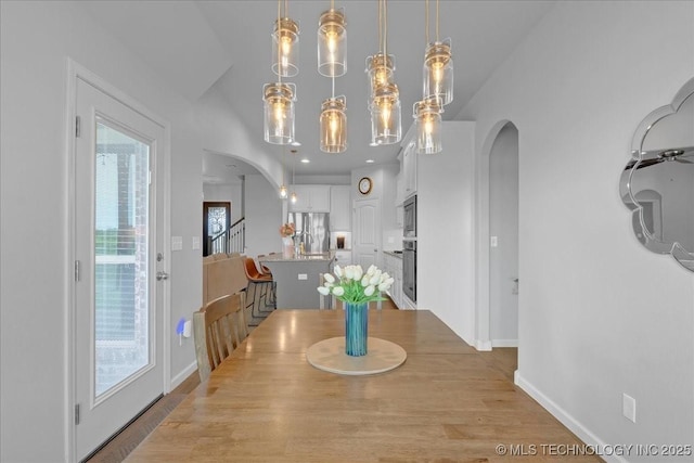 30130 S Maxine Ave, Inola, OK 74036 - dining space featuring arched walkways and wood finished floors