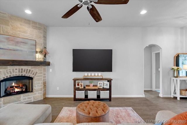 30130 S Maxine Ave, Inola, OK 74036 - living area featuring ceiling fan, arched walkways, a large fireplace, recessed lighting, and wood finished floors