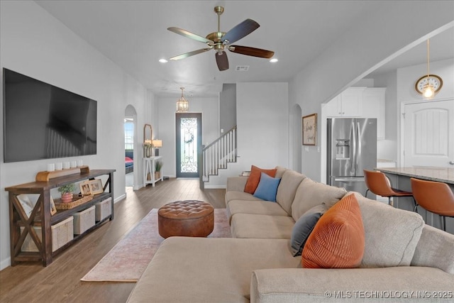 30130 S Maxine Ave, Inola, OK 74036 - living area with arched walkways, wood finished floors, a ceiling fan, stairway, and recessed lighting