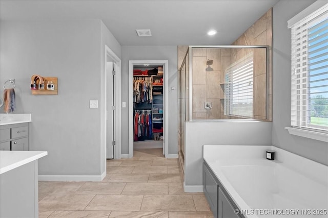 30130 S Maxine Ave, Inola, OK 74036 - bathroom featuring a garden tub, a shower stall, a spacious closet, recessed lighting, and vanity