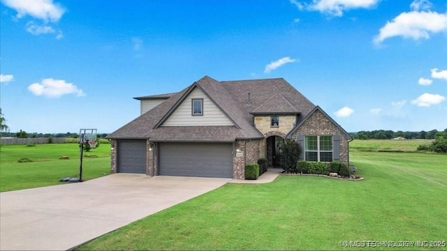 30130 S Maxine Ave, Inola, OK 74036 - view of front of home featuring a front yard, concrete driveway, brick siding, and roof with shingles
