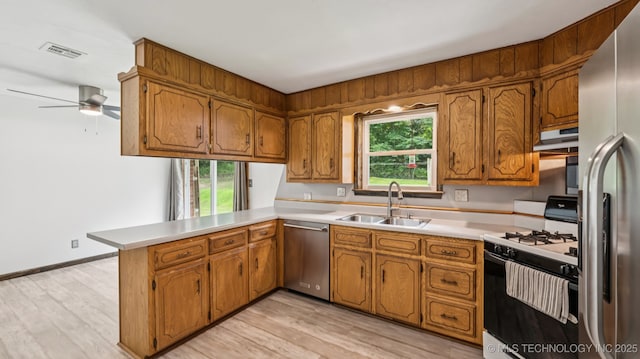 20512 E 430th Rd, Claremore, OK 74017 - kitchen with appliances with stainless steel finishes, a peninsula, and brown cabinetry