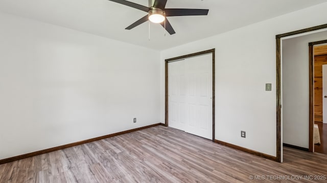 20512 E 430th Rd, Claremore, OK 74017 - unfurnished bedroom featuring wood finished floors, a closet, and a ceiling fan