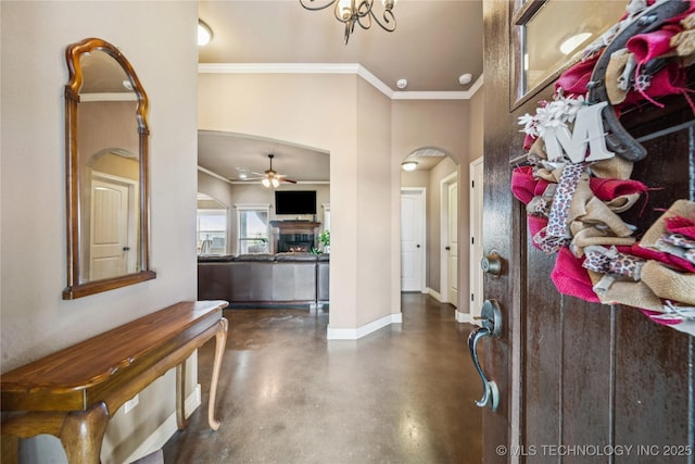 5983 E 137th St, Collinsville, OK 74021 - foyer featuring arched walkways, concrete flooring, crown molding, a ceiling fan, and a warm lit fireplace