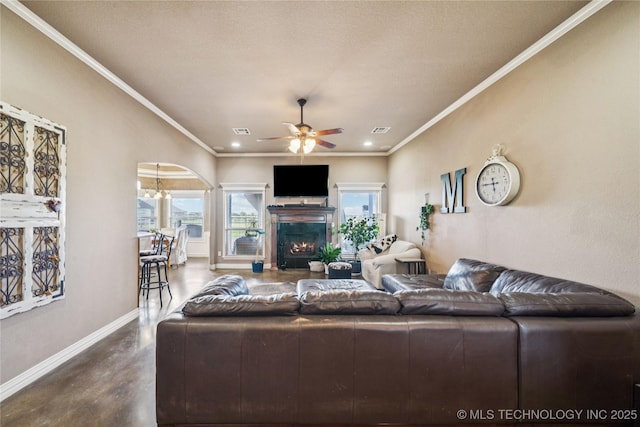 5983 E 137th St, Collinsville, OK 74021 - living room featuring ceiling fan, finished concrete flooring, arched walkways, recessed lighting, and ornamental molding