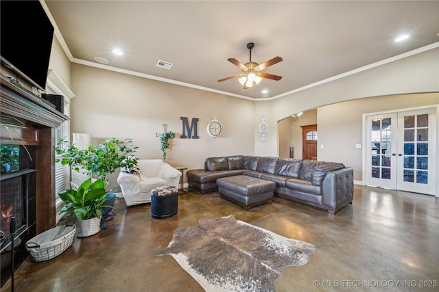 5983 E 137th St, Collinsville, OK 74021 - living room with concrete flooring, a fireplace, arched walkways, french doors, and recessed lighting