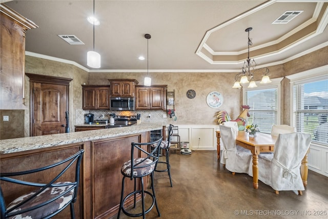 5983 E 137th St, Collinsville, OK 74021 - kitchen with stainless steel microwave, finished concrete flooring, ornamental molding, light stone countertops, and a breakfast bar