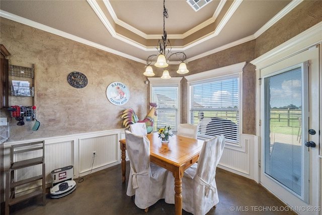 5983 E 137th St, Collinsville, OK 74021 - dining room featuring a wainscoted wall, a decorative wall, ornamental molding, a raised ceiling, and a chandelier