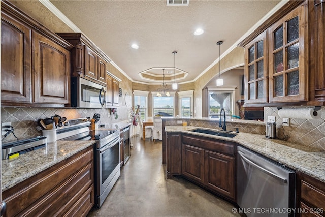 5983 E 137th St, Collinsville, OK 74021 - kitchen featuring stainless steel appliances, finished concrete floors, glass insert cabinets, light stone counters, and ornamental molding