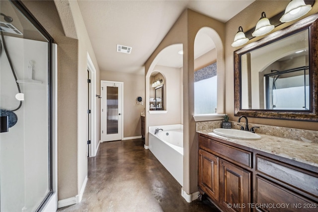 5983 E 137th St, Collinsville, OK 74021 - bathroom featuring finished concrete floors, a shower stall, a bath, and vanity