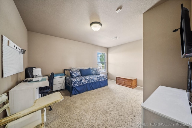 5983 E 137th St, Collinsville, OK 74021 - carpeted bedroom featuring a textured ceiling and a desk