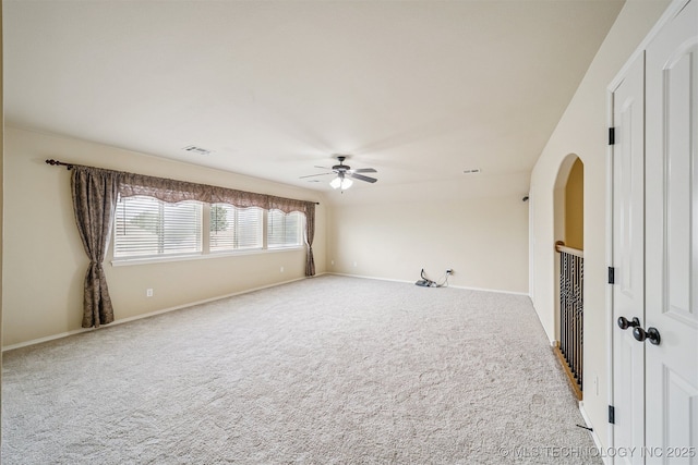 4204 N Maple Pl, Broken Arrow, OK 74012 - carpeted empty room with a ceiling fan and arched walkways