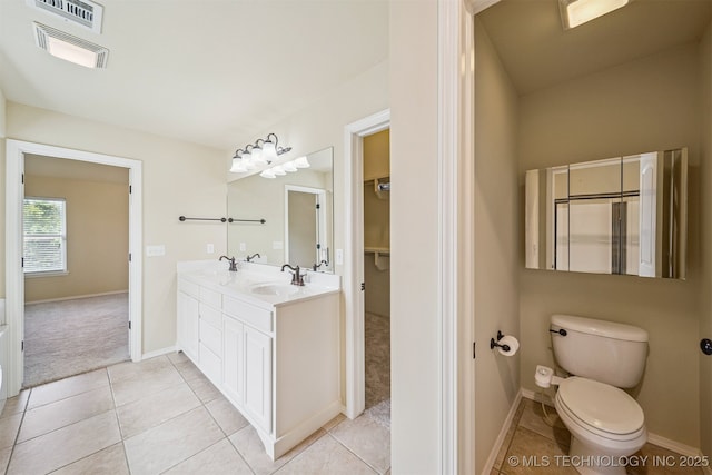 4204 N Maple Pl, Broken Arrow, OK 74012 - bathroom featuring double vanity, tile patterned flooring, and a spacious closet