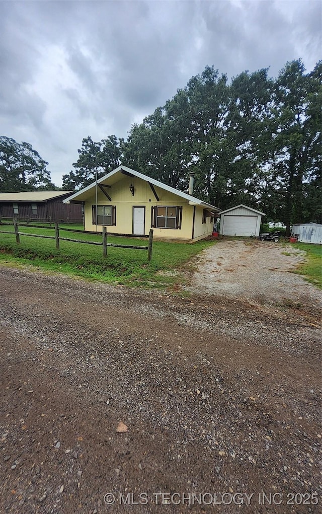 22 Quail Dr, Durant, OK 74701 - view of front of house featuring dirt driveway, a garage, and an outbuilding