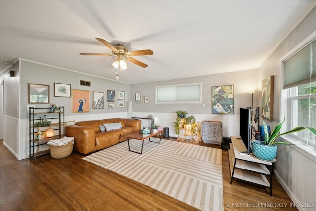5718 E 27th St, Tulsa, OK 74114 - living room featuring wood finished floors, a ceiling fan, and ornamental molding