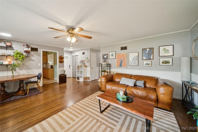 5718 E 27th St, Tulsa, OK 74114 - living room with ceiling fan, wood finished floors, crown molding, and wainscoting