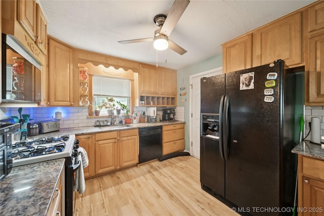 5718 E 27th St, Tulsa, OK 74114 - kitchen with black appliances, a ceiling fan, tasteful backsplash, light wood finished floors, and light stone countertops