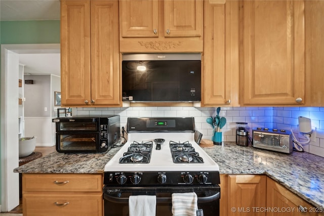 5718 E 27th St, Tulsa, OK 74114 - kitchen featuring black range with gas stovetop, stainless steel microwave, tasteful backsplash, and light stone counters