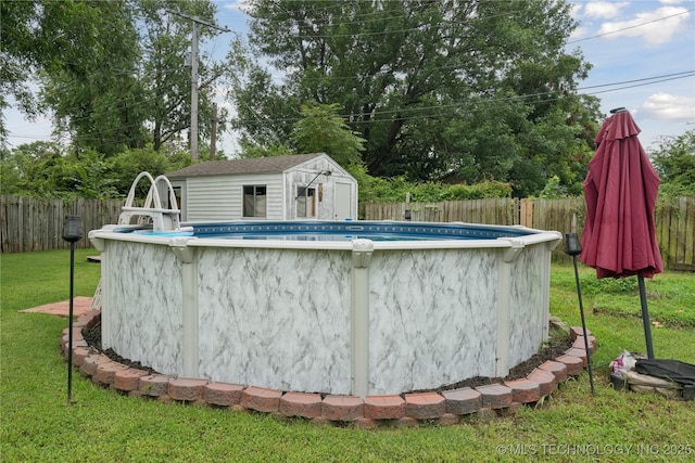 5718 E 27th St, Tulsa, OK 74114 - view of swimming pool featuring a fenced backyard and a storage unit