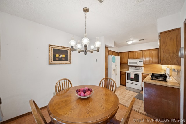 1234 S 110th E Ave Unit 59-4A, Tulsa, OK 74128 - dining area featuring a chandelier and a textured ceiling