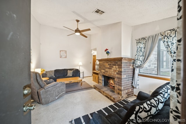 1234 S 110th E Ave Unit 59-4A, Tulsa, OK 74128 - carpeted living room with ceiling fan, a fireplace, lofted ceiling, and a textured ceiling