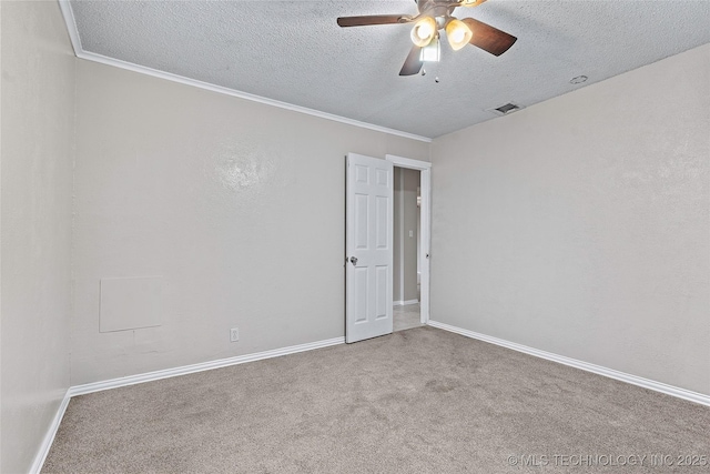 1015 NW Maxwell, Ardmore, OK 73401 - empty room with a textured ceiling, carpet floors, ceiling fan, and crown molding