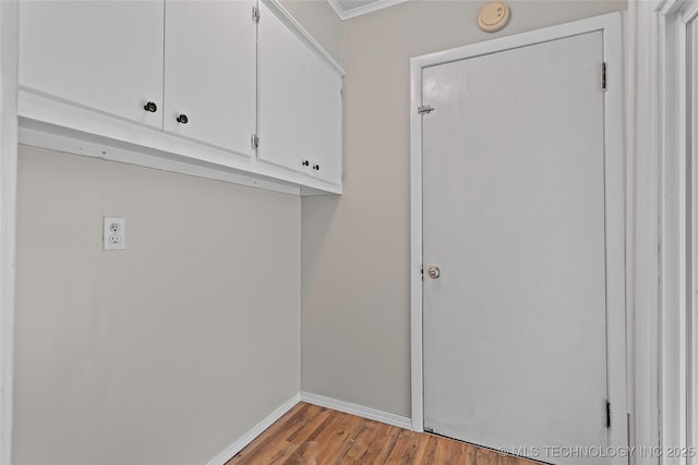 1015 NW Maxwell, Ardmore, OK 73401 - laundry room featuring light wood-style floors and baseboards