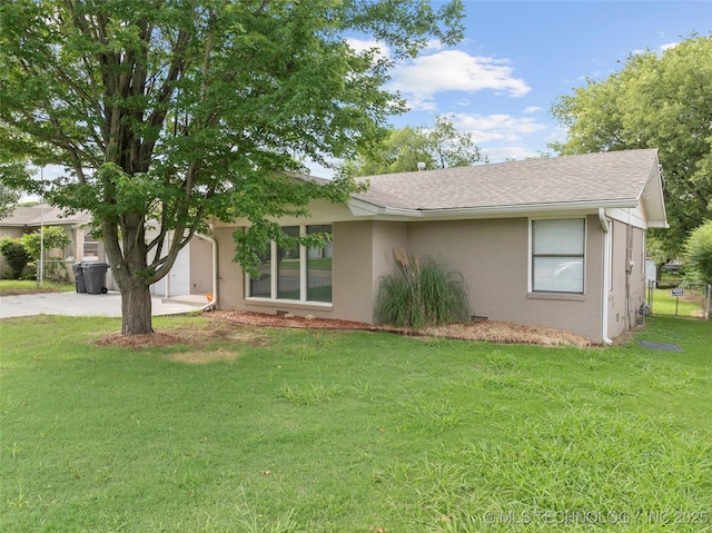 1015 NW Maxwell, Ardmore, OK 73401 - view of front of home with brick siding, a shingled roof, and driveway
