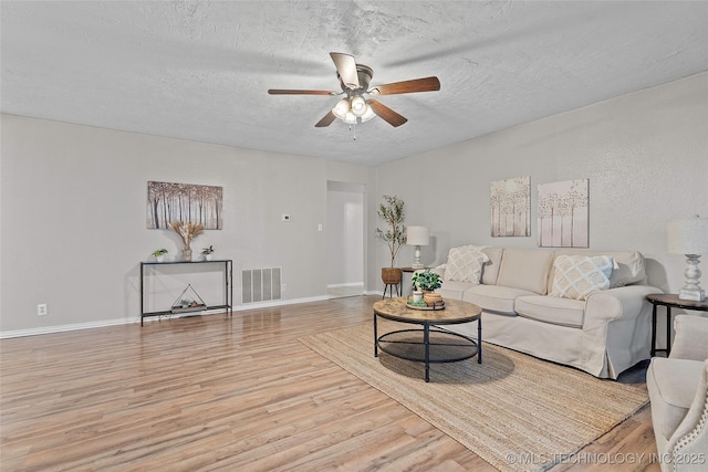 1015 NW Maxwell, Ardmore, OK 73401 - living area with wood finished floors, a ceiling fan, and a textured ceiling