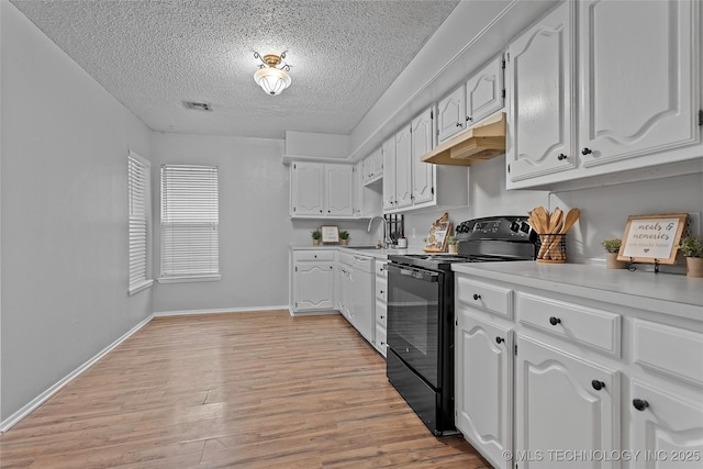 1015 NW Maxwell, Ardmore, OK 73401 - kitchen featuring black range with electric cooktop, under cabinet range hood, a textured ceiling, light wood-style flooring, and light countertops