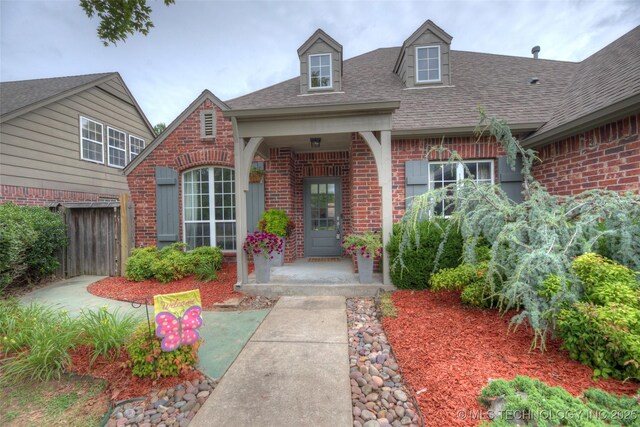 7349 E 119th Pl S, Bixby, OK 74008 - doorway to property with brick siding and roof with shingles