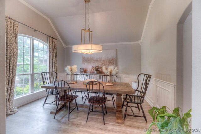 7349 E 119th Pl S, Bixby, OK 74008 - dining space featuring wood finished floors, arched walkways, lofted ceiling, crown molding, and a wainscoted wall