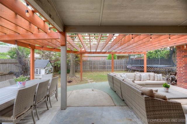 7349 E 119th Pl S, Bixby, OK 74008 - fenced backyard featuring a trampoline, a storage unit, a patio, outdoor dining area, and an outdoor living space