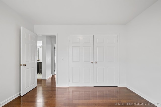 3039 W 69th Pl, Tulsa, OK 74132 - unfurnished bedroom with dark wood-style flooring and a closet