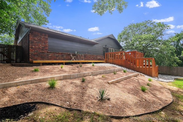 3039 W 69th Pl, Tulsa, OK 74132 - view of property exterior featuring brick siding and a wooden deck