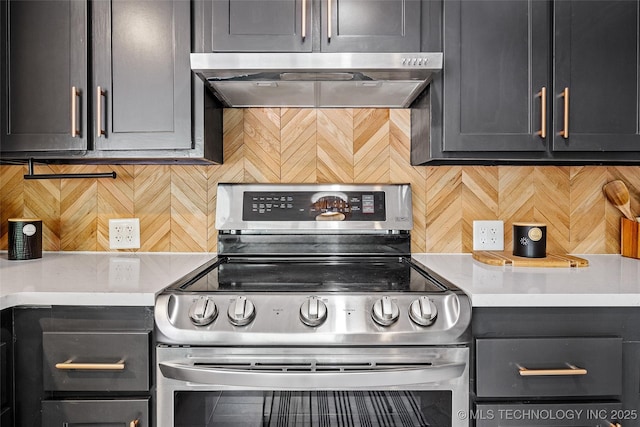 3039 W 69th Pl, Tulsa, OK 74132 - kitchen with stainless steel range with electric stovetop, tasteful backsplash, range hood, and light countertops