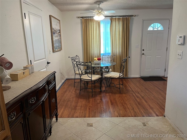4908 N Xanthus Ave, Tulsa, OK 74130 - tiled dining area with a ceiling fan and a textured ceiling